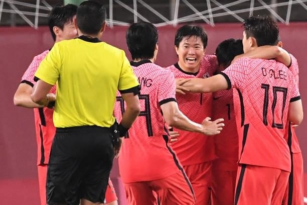 South Korea's midfielder Lee Dong-gyeong celebrates with teammates after scoring a goal during the Tokyo 2020 Olympic Games men's group B first round...