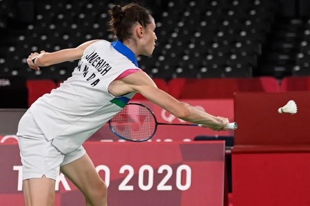Canada's Rachel Honderich hits a shot in her women's doubles badminton group stage match with Canada's Kristen Tsai against Japan's Wakana Nagahara...