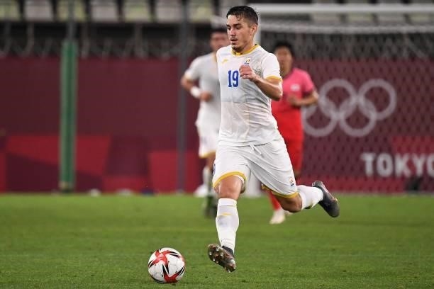 Romania's forward Andrei Sintean controls the ball during the Tokyo 2020 Olympic Games men's group B first round football match between Romania and...
