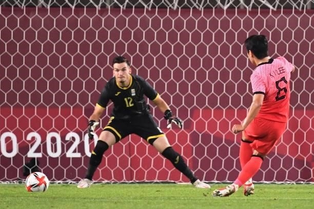 South Korea's midfielder Lee Kang-in shoots and scores past Romania's goalkeeper Marian Aioani during the Tokyo 2020 Olympic Games men's group B...