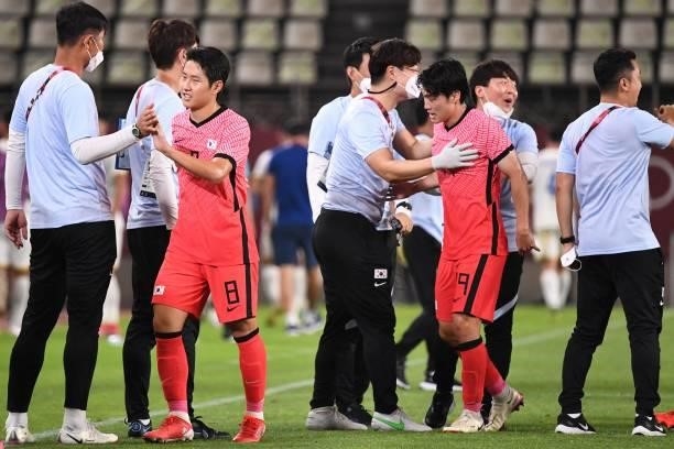 South Korea's midfielder Lee Kang-in celebrates after South Korea won the Tokyo 2020 Olympic Games men's group B first round football match between...