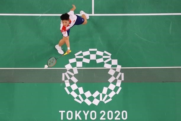 China's Huang Dongping hits a shot in her mixed doubles badminton group stage match with China's Wang Yilyu against Hong Kong's Tang Chun Man and...