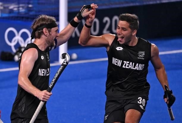 New Zealand's Blair Tarrant celebrates with teammate George Muir after scoring against Spain during their men's pool A match of the Tokyo 2020...