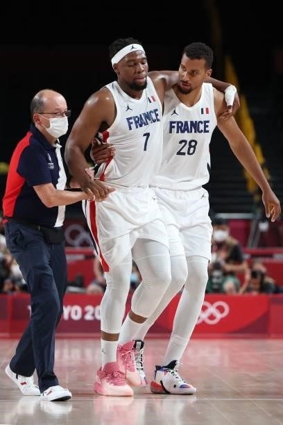 France's Guerschon Yabusele is helped by his teammate Petr Cornelie as he walks off the court in the men's preliminary round group A basketball match...
