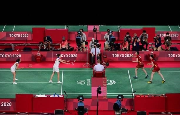 Canada's Rachel Honderich serves next to Canada's Kristen Tsai against Japan's Wakana Nagahara and Japan's Mayu Matsumoto in their women's doubles...