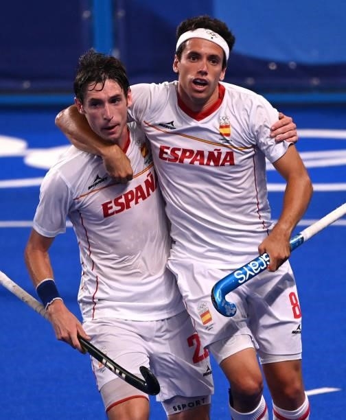 Spain's Enrique Gonzalez celebrates with teammate Vicenc Ruiz after scoring against New Zealand during their men's pool A match of the Tokyo 2020...