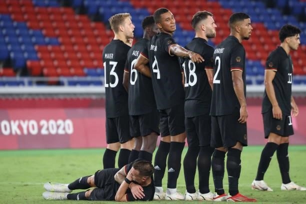 Germany's players set up a wall ahead of a free-kick during the Tokyo 2020 Olympic Games men's group D first round football match between Saudi...