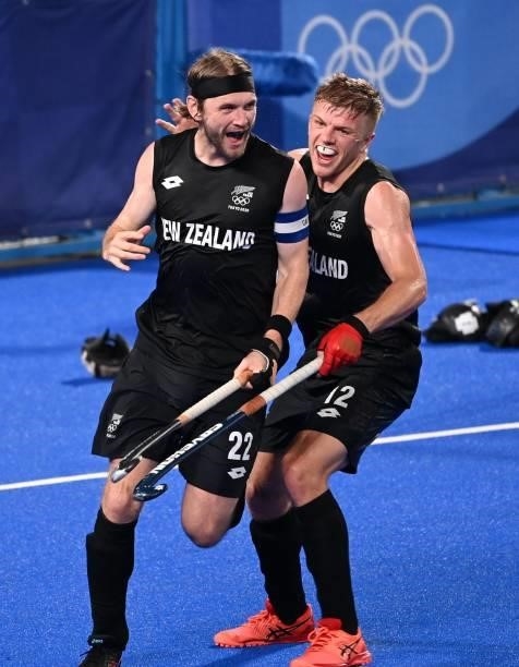 New Zealand's Blair Tarrant celebrates with teammate Sam Lane after scoring against Spain during their men's pool A match of the Tokyo 2020 Olympic...