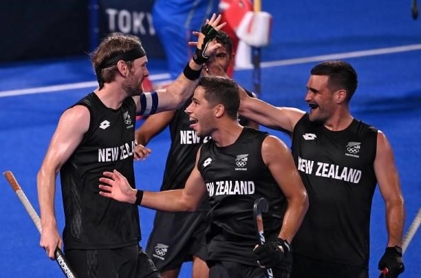 New Zealand's Blair Tarrant celebrates with teammates after scoring against Spain during their men's pool A match of the Tokyo 2020 Olympic Games...