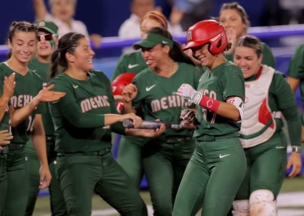 Mexico's Anissa Urtez is celebrated her two run homer by teammates during the fifth inning of the Tokyo 2020 Olympic Games softball opening round...