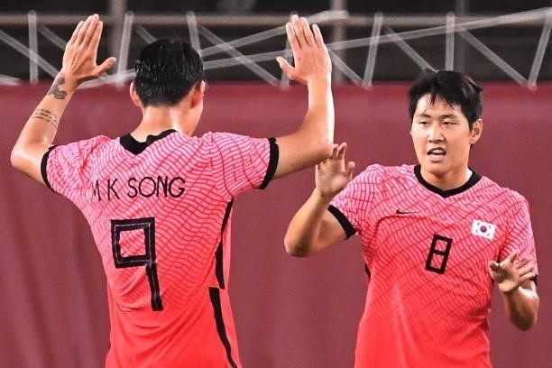 South Korea's midfielder Lee Kang-in celebrates with South Korea's forward Song Min-kyu after scoring a goal during the Tokyo 2020 Olympic Games...