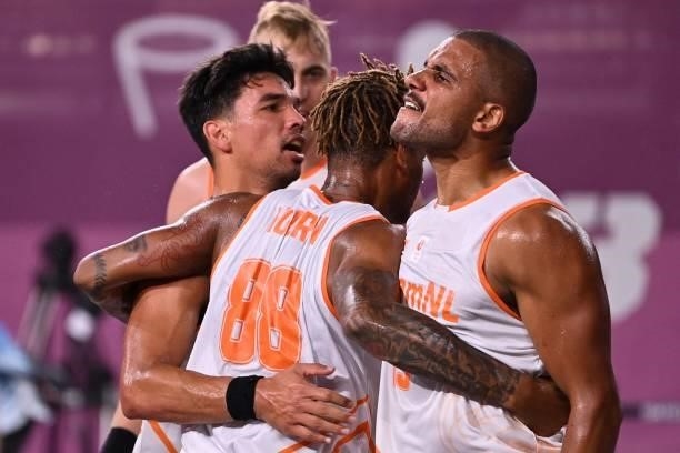 Netherlands' Dimeo Van Der Horst and teammates after wining the men's first round 3x3 basketball match between Netherlands and China at the Aomi...