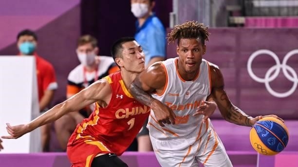 China's Gao Shiyan fights for the ball with Netherlands' Jessey Voorn during the men's first round 3x3 basketball match between Netherlands and China...