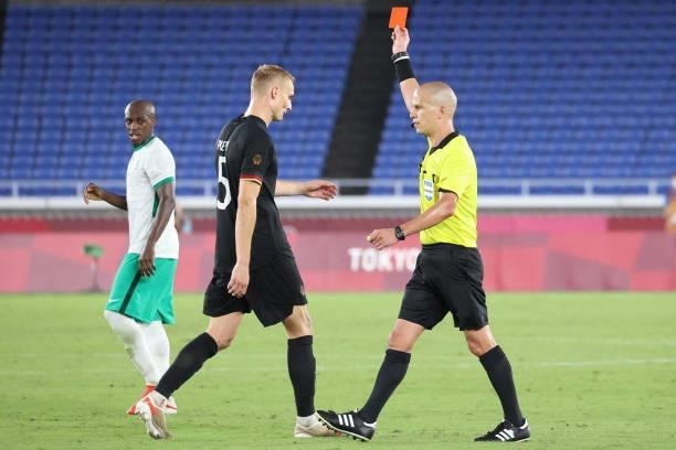 South African referee Victor Gomes presents a red card to Germany's defender Amos Pieper during the Tokyo 2020 Olympic Games men's group D first...