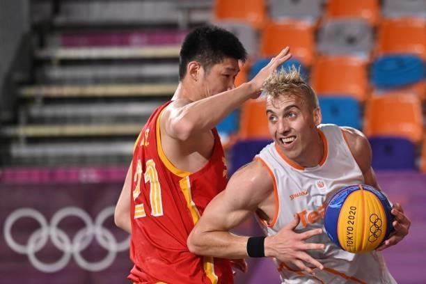 Netherlands' Ross Bekkering fights for the ball with China's Hu Jinqiu during the men's first round 3x3 basketball match between Netherlands and...