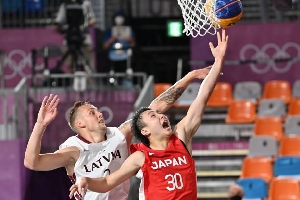 Japan's Keisei Tominaga fights for the ball with Latvia's Karlis Lasmanis during the men's first round 3x3 basketball match between Latvia and Japan...