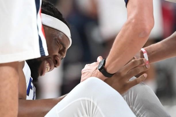 France's Guerschon Yabusele reacts in pain after an injury during the men's preliminary round group A basketball match between France and USA during...