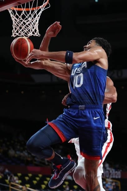 S Jayson Tatum scores a basket in the men's preliminary round group A basketball match between France and USA during the Tokyo 2020 Olympic Games at...