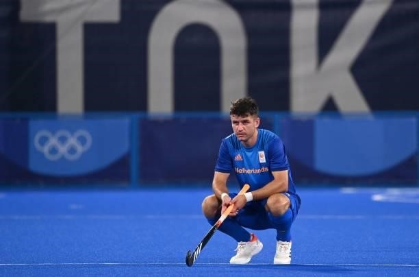 Netherlands' Robbert Kemperman squats during the men's pool B match of the Tokyo 2020 Olympic Games field hockey competition against South Africa, at...