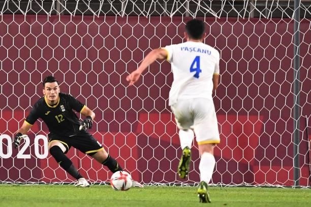 Romania's goalkeeper Marian Aioani concedes a penalty shot form South Korea's midfielder Lee Kang-in during the Tokyo 2020 Olympic Games men's group...
