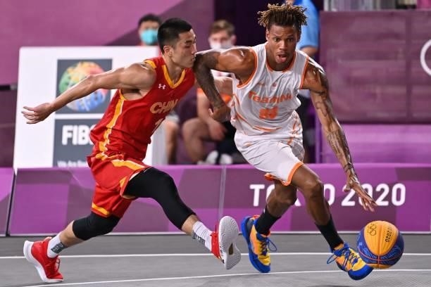 China's Gao Shiyan fights for the ball with Netherlands' Jessey Voorn during the men's first round 3x3 basketball match between Netherlands and China...