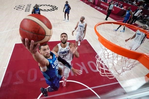 S Zachary Lavine goes for the basket past France's Rudy Gobert during the men's preliminary round group A basketball match between France and USA...