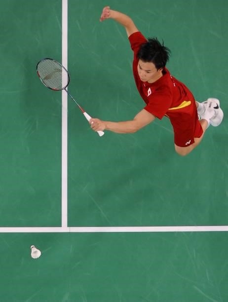 Japan's Yuta Watanabe hits a shot in his mixed doubles badminton group stage match with Japan's Arisa Higashino against Australia's Gronya Somerville...