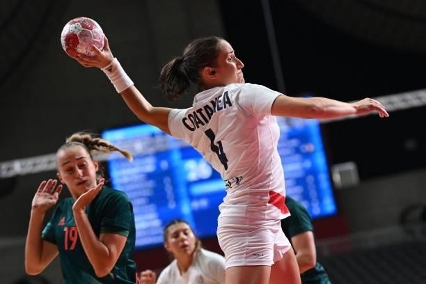 France's right wing Pauline Coatanea shoots past Hungary's left wing Greta Marton during the women's preliminary round group B handball match between...