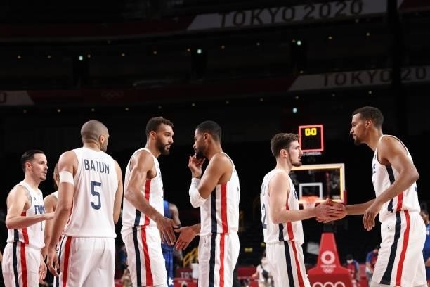 French players celebrate after their win in the men's preliminary round group A basketball match between France and USA during the Tokyo 2020 Olympic...