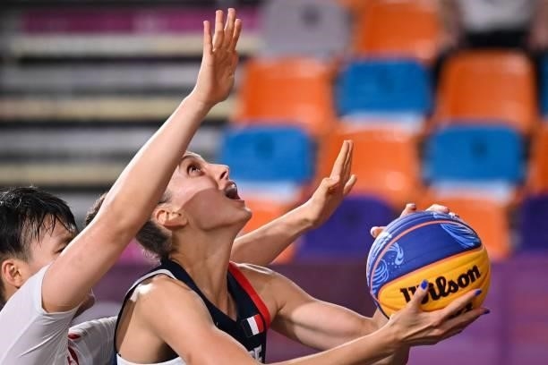 China's Yang Shuyu fights for the ball with France's Ana Maria Filip during the women's first round 3x3 basketball match between China and France at...