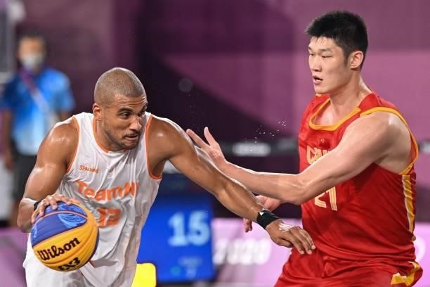 Netherlands' Dimeo Van Der Horst fights for the ball with China's Hu Jinqiu during the men's first round 3x3 basketball match between Netherlands and...