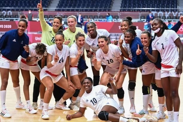 France's players pose as they celebrate their victory after the women's preliminary round group B handball match between Hungary and France of the...