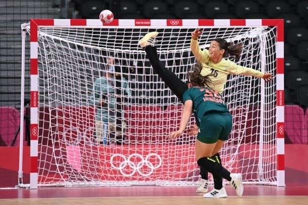 France's goalkeeper Cleopatre Darleux fails to stop a shot by Hungary's centre back Petra Vamos during the women's preliminary round group B handball...