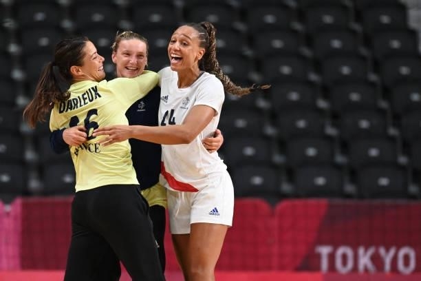 France's goalkeeper Cleopatre Darleux, France's goalkeeper Amandine Leynaud and France's pivot Beatrice Edwige celebrate their victory after the...