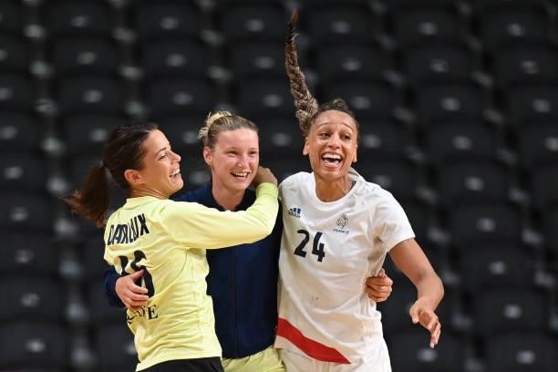 France's goalkeeper Cleopatre Darleux, France's goalkeeper Amandine Leynaud and France's pivot Beatrice Edwige celebrate their victory after the...
