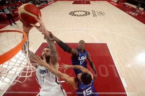 France's Guerschon Yabusele goes to the basket as USA's Devin Booker tries to block in the men's preliminary round group A basketball match between...
