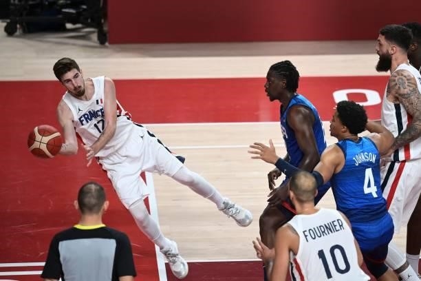 France's Nando De Colo makes a pass to France's Evan Fournier for the ball with USA's Jrue Holiday during the men's preliminary round group A...