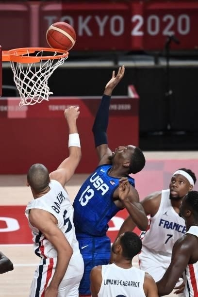 S Edrice Femi Adebayo goes for the basket past France's Nicolas Batum during the men's preliminary round group A basketball match between France and...