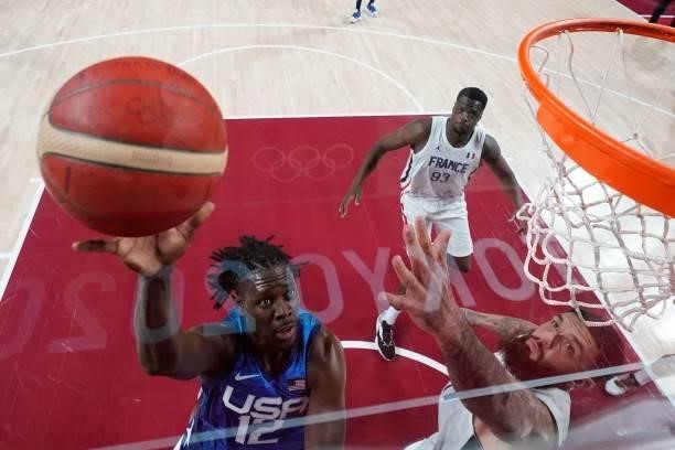 S Jrue Holiday goes for the basket past France's Vincent Poirier during the men's preliminary round group A basketball match between France and USA...