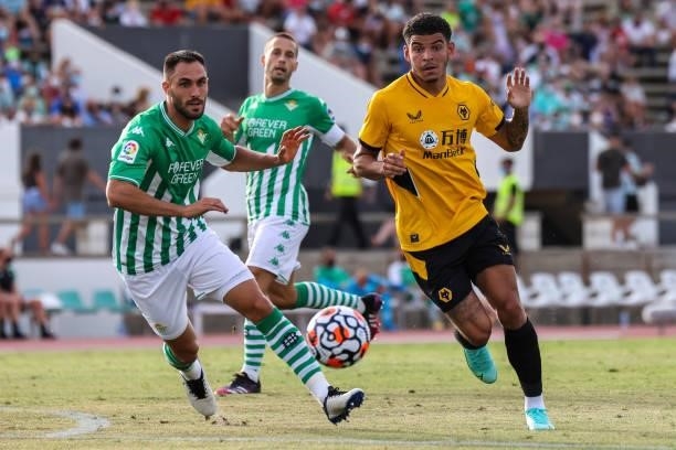 Morgan Gibbs-White of Wolverhampton Wanderes FC and Victor Ruiz of Real Betis during the pre-season friendly match between Real Betis and...