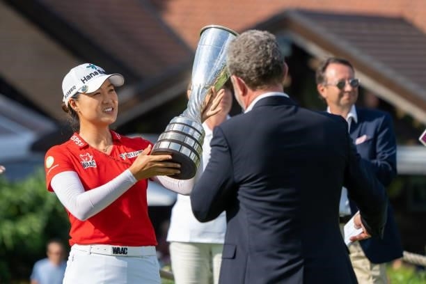 Minjee Lee of Australia celebrates with the trophy after winning the tournament during day four of the The Amundi Evian Championship at Evian Resort...