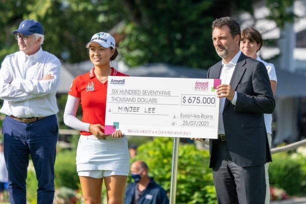 Minjee Lee of Australia receives a cheque after winning the tournament during day four of the The Amundi Evian Championship at Evian Resort Golf Club...