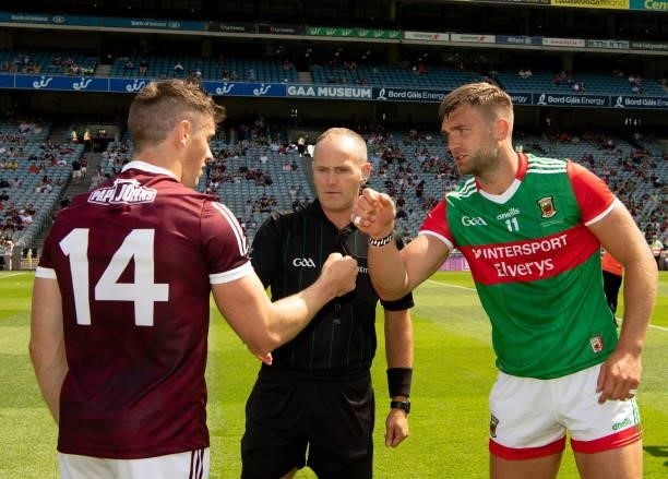 Dublin , Ireland - 25 July 2021; The two captains, Aidan O'Shea and Shane Walsh of Galway, greet each other in front of referee Conor Lane before the...