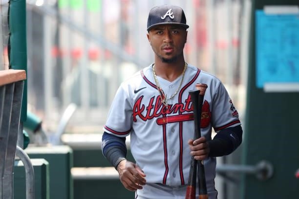 Ozzie Albies of the Atlanta Braves enters the dugout with his bats before a game against the Philadelphia Phillies at Citizens Bank Park on July 25,...