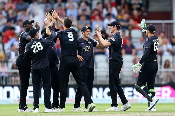 Steven Finn celebrates with team mates after taking the wicket of Miles Hammond of Birmingham Phoenix during The Hundred match between Manchester...