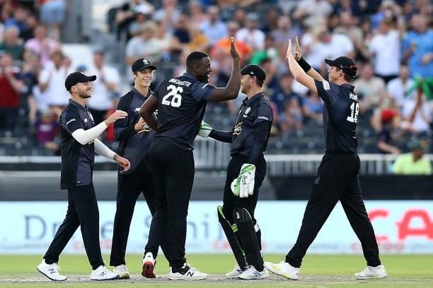 Carlos Brathwaite of Manchester Originals celebrates with team mates after taking a wicket during The Hundred match between Manchester Originals Men...