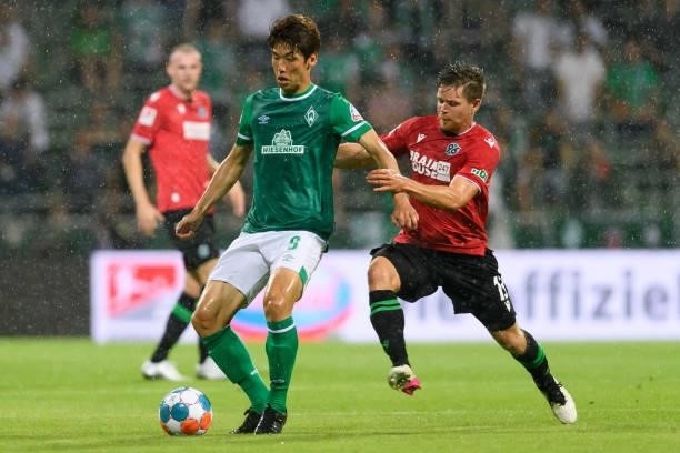 Yuya Osako of SV Werder Bremen and Dominik Kaiser of Hannover 96 battle for the ball during the Second Bundesliga match between SV Werder Bremen and...