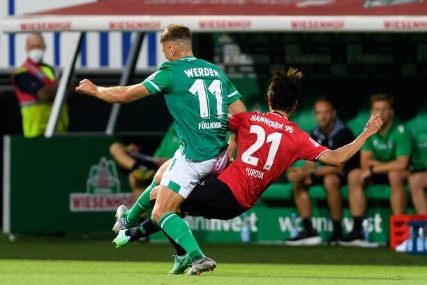 Niclas Fuellkrug of SV Werder Bremen and Sei Muroya of Hannover 96 battle for the ball during the Second Bundesliga match between SV Werder Bremen...