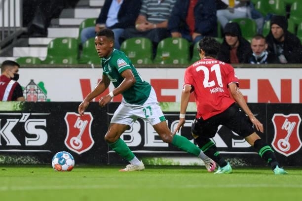 Sei Muroya of Hannover 96 and Felix Agu of SV Werder Bremen battle for the ball during the Second Bundesliga match between SV Werder Bremen and...