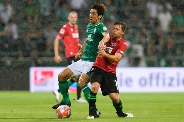 Yuya Osako of SV Werder Bremen and Dominik Kaiser of Hannover 96 battle for the ball during the Second Bundesliga match between SV Werder Bremen and...
